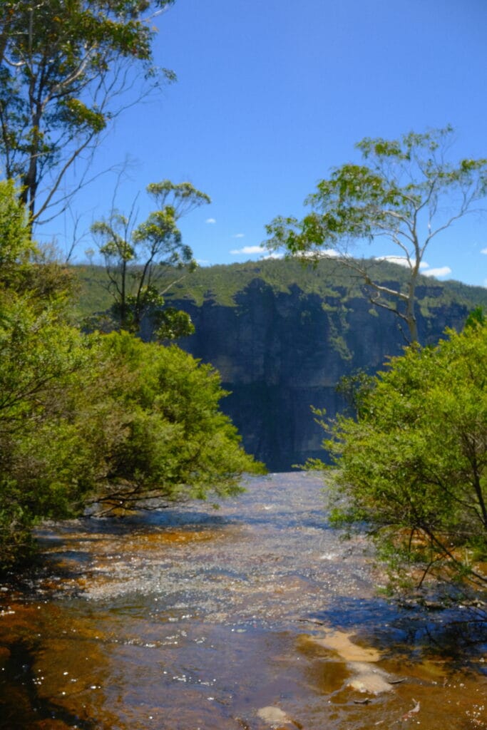 Top view perspective of a lake running off a cliff