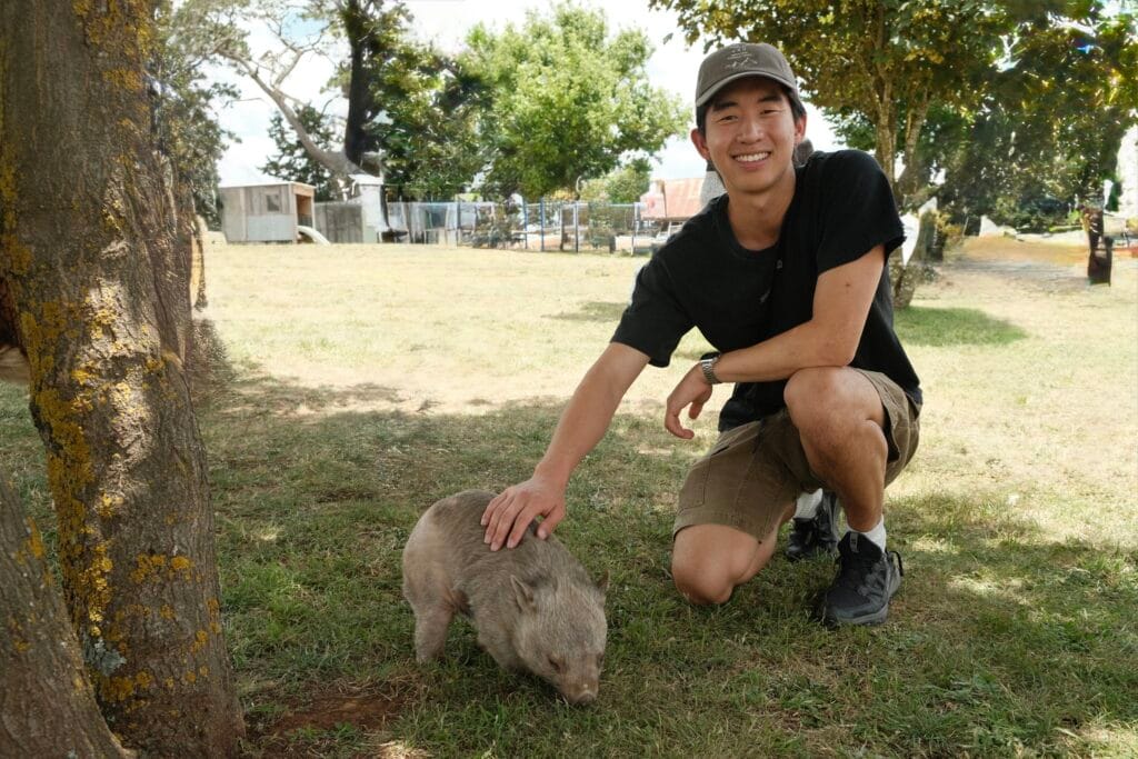 Me smiling next to Karl the baby wombat