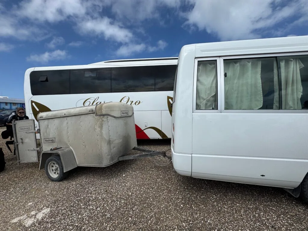 A small trailer behind the mini bus