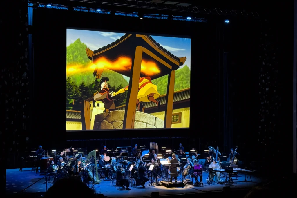 Orchestra on stage with Avatar The Last Airbender on scree.