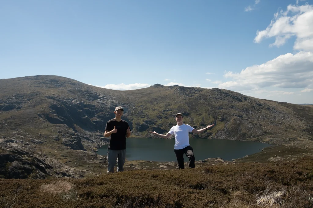 Me and my friend smiling in front of Blue Lake