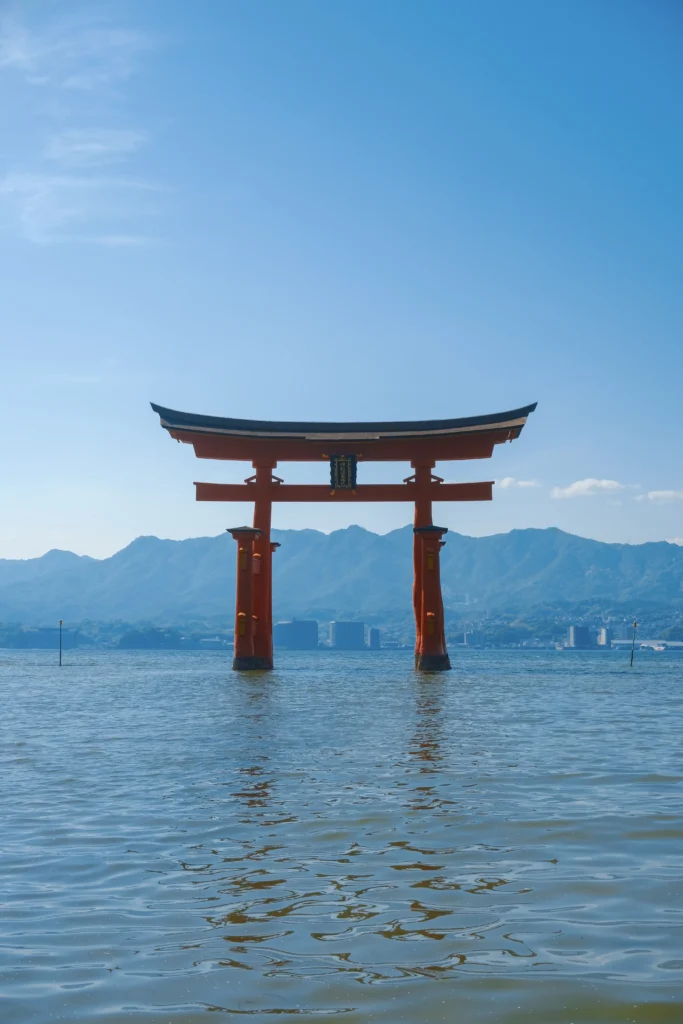 Hiroshima_Japan_SeanSojourns Red tori gate in blue water Japan