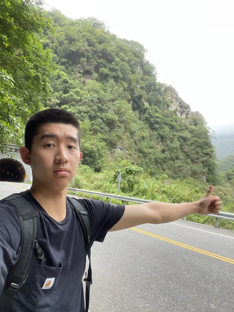 Me putting my thumb up waiting for cars.
