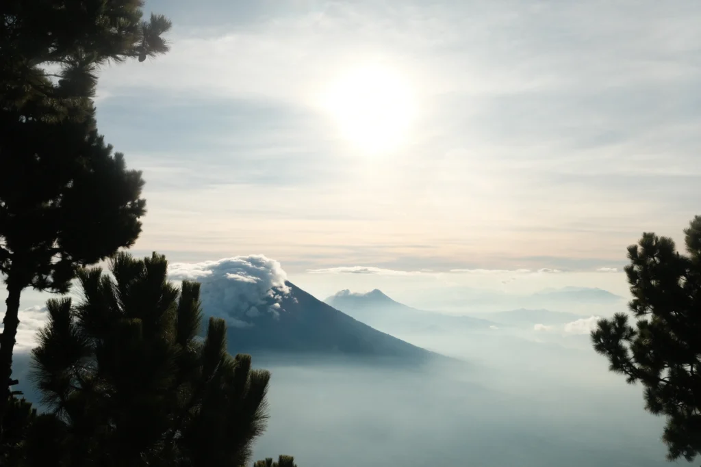 Two mountains above the clouds at sunrise.